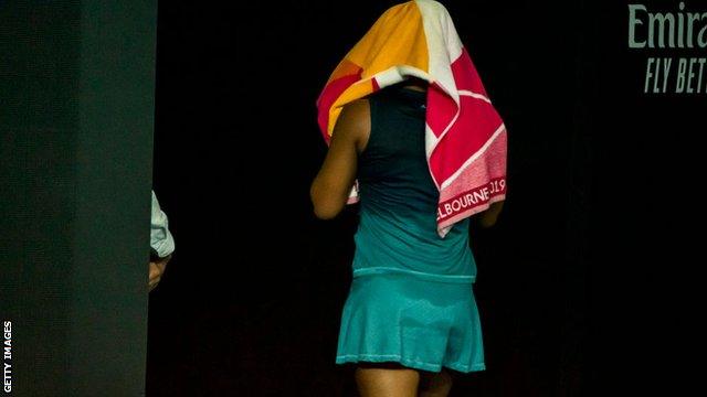 Naomi Osaka walking off court after losing the second set