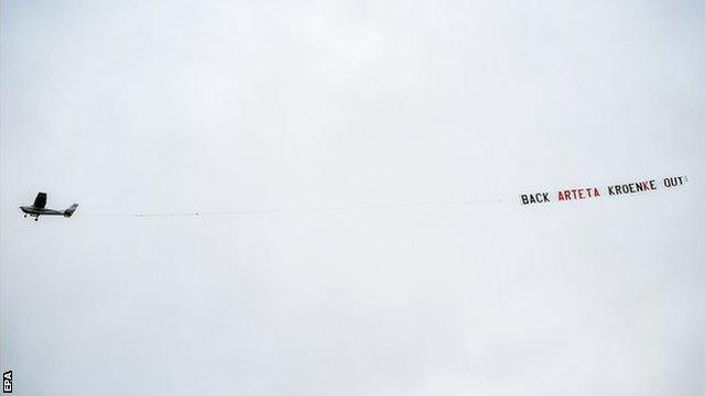 A plane towing a banner flies over Villa Park during Aston Villa's match with Arsenal