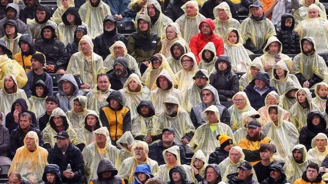 Wolverhampton Wanderers fans wear ponchos in the rain during a Premier League match