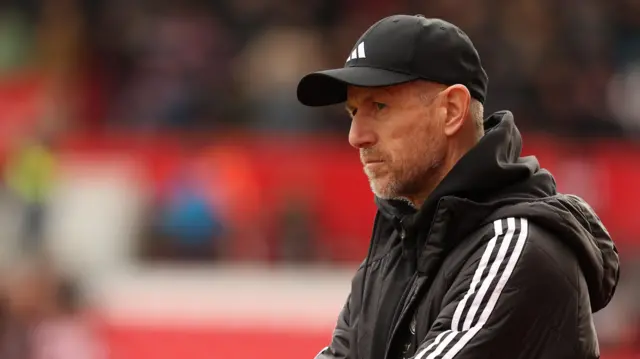 A close up of Gary Rowett wearing a black Adidas hat and jacket