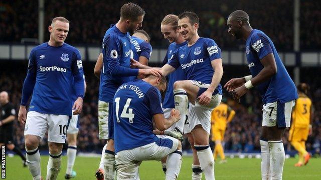 Cenk Tosun celebrates his first goal Goodison Park goal by pretending to polish the boots of Leighton Baines, who provided the assist