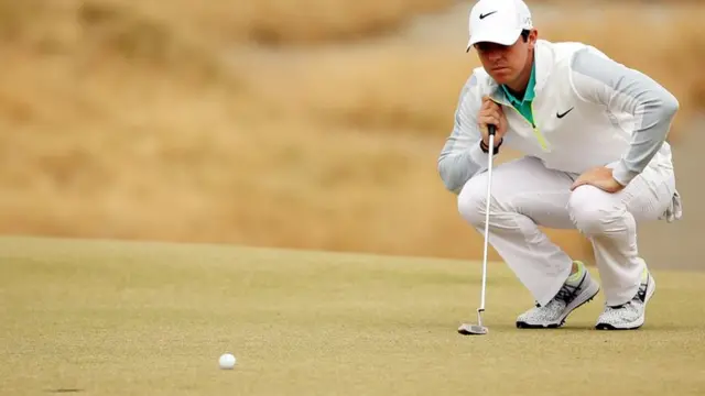 Rory McIlroy lines up a putt