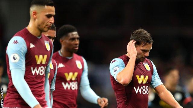 Aston Villa players react during their team's 6-1 home defeat to Manchester City