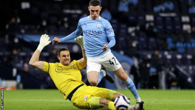 Southampton keeper Alex McCarthy challenges Manchester City's Phil Foden