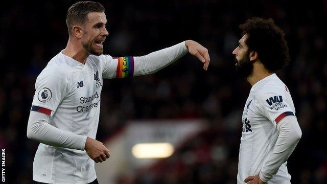 Jordan Henderson talks to Liverpool team-mate Mohamed Salah