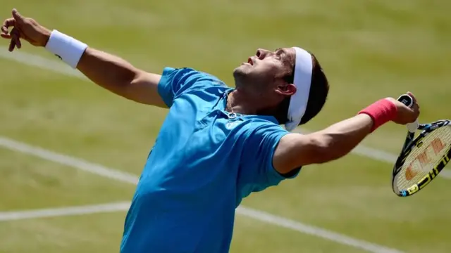 Gilles Muller serves