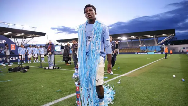 Ryan McAidoo of Manchester City celebrates with the FA Youth Cup trophy