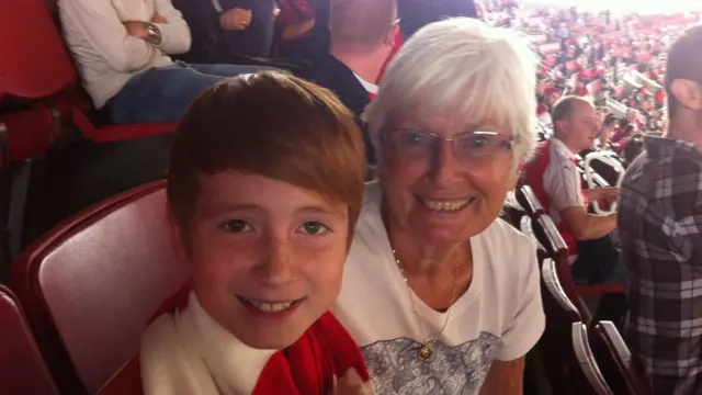 An image of a grandmother and her grandson in Emirates Stadium