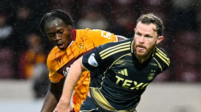 Motherwell's Emmanuel Longelo and Aberdeen's Nicky Devlin
