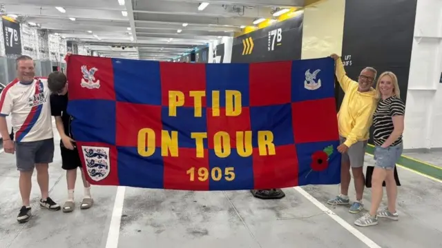Crystal Palace fans pose with flag