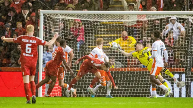 Dundee United goalkeeper Jack Walton makes a save to deny Aberdeen's Ester Sokler