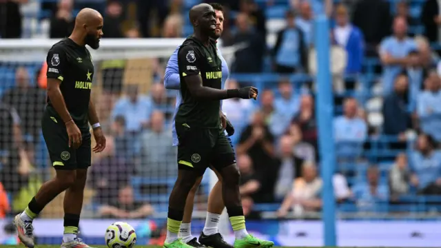 Yoane Wissa is helped off pitch against Manchester City