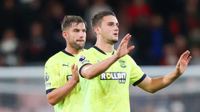 Taylor Harwood-Bellis of Southampton gestures an apology to the travelling supporters