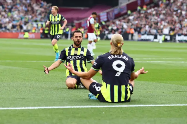 Erling Haaland and Bernado Silva celebrate the former scoring for Manchester City at West Ham