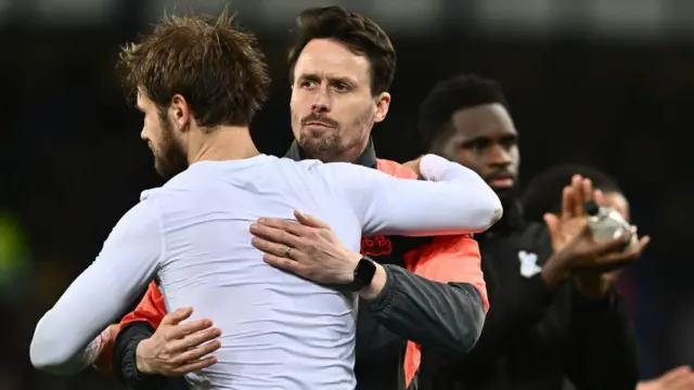 Assistant manager Paddy McCarthy embraces Joachim Andersen