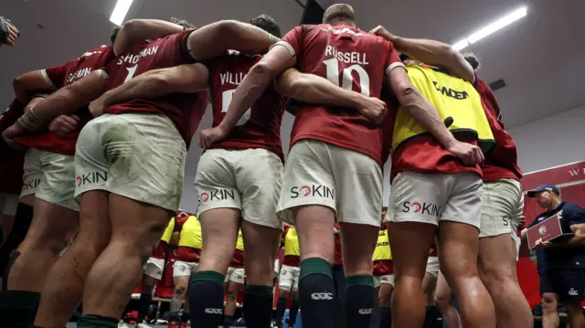 The Lions team huddle in the dressing room at half-time