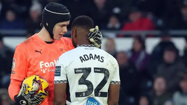 Derby County goalkeeper Jacob Widell Zetterstrom with his team-mate Ebou Adams