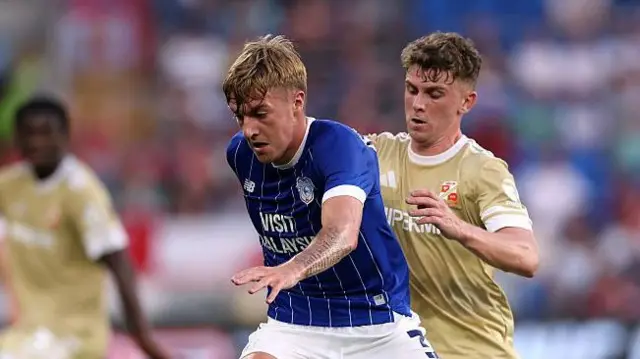 Joel Bagan is challenged by Gavin Kilkenny during the Carabao Cup first-round match between Cardiff City and Swindon Town last August 