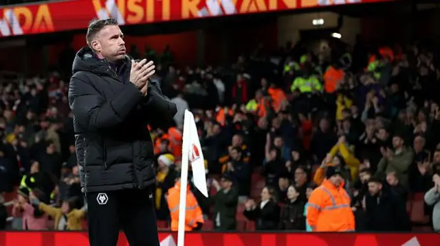 Rob Edwards applauds the Wolves fans following the Premier League defeat at Arsenal 