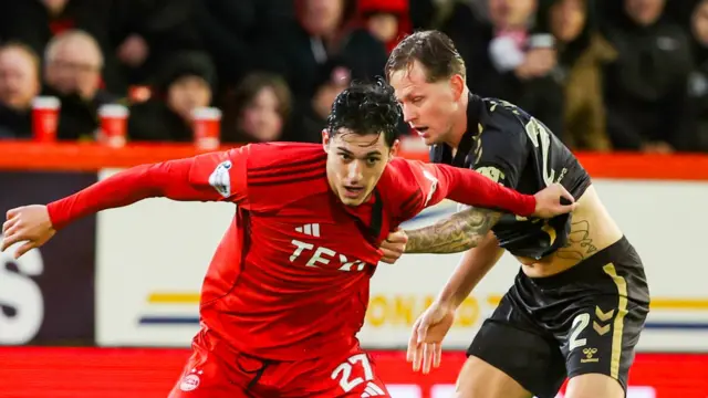Aberdeen's Marko Lazetic and Hearts' Frankie Kent