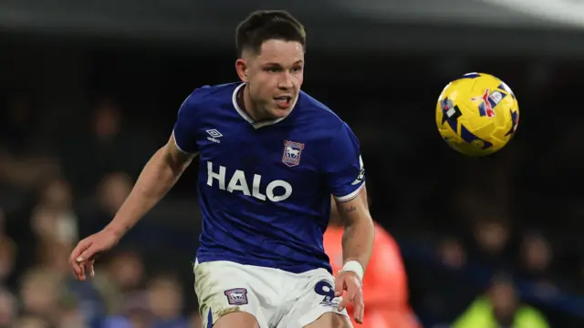 A photo of George Hirst watching a yellow EFL football while wearing Ipswich Town's home kit