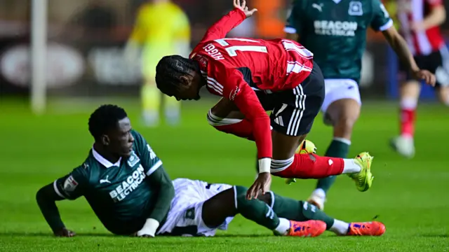 Brendan Wiredu tackles Akeel Higgins during the Devon derby