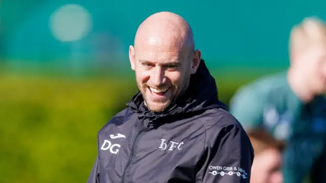 David Gray of Hibs laughs during training
