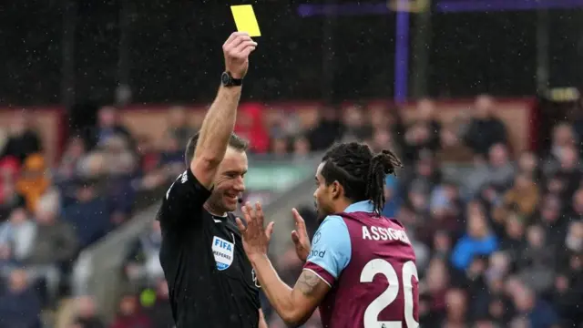  Burnley defender Lorenz Assignon is shown a yellow card