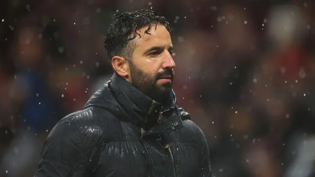 Ruben Amorim looks on in the pouring rain