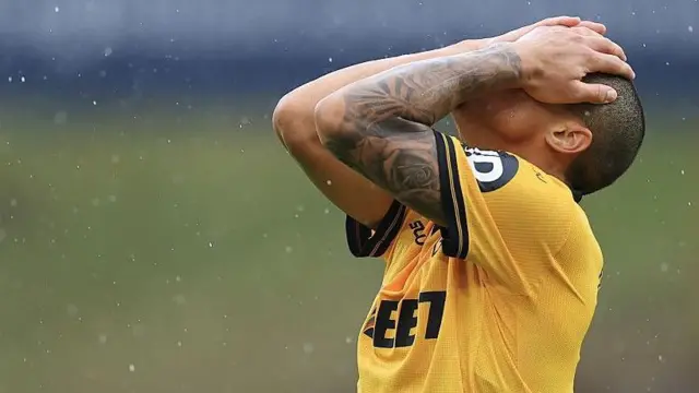 Joao Gomes of Wolves stands with his hands on his head dejected