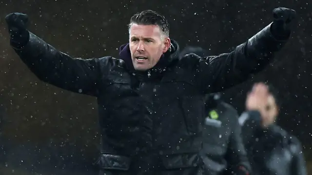 Rob Edwards with his arms out in celebration