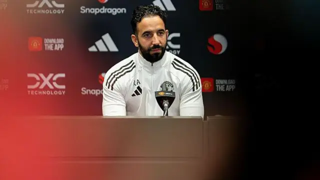 Ruben Amorim sitting at a news conference table