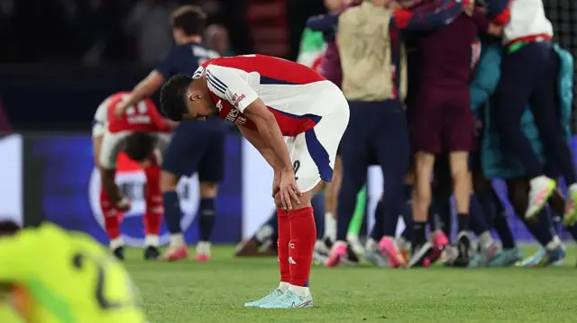 William Saliba looks down dejected after defeat