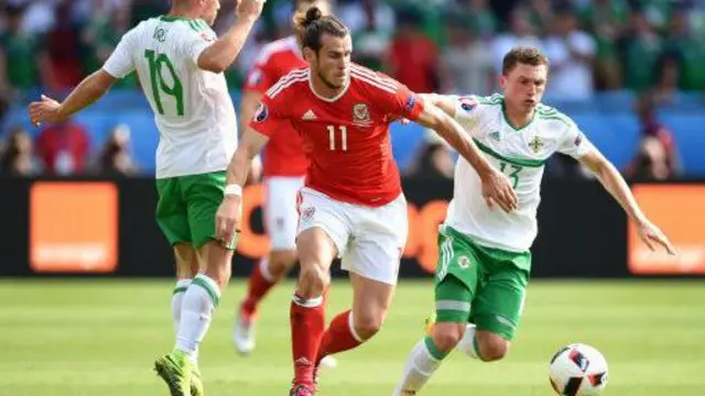 Gareth Bale of Wales (left) and Corry Evans of Northern Ireland race for the ball