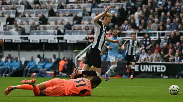 Anthony Gordon is brought down for a penalty by Manchester City's Brazilian goalkeeper #31 Ederson during the English Premier League football match between Newcastle United and Manchester City at St James' Park