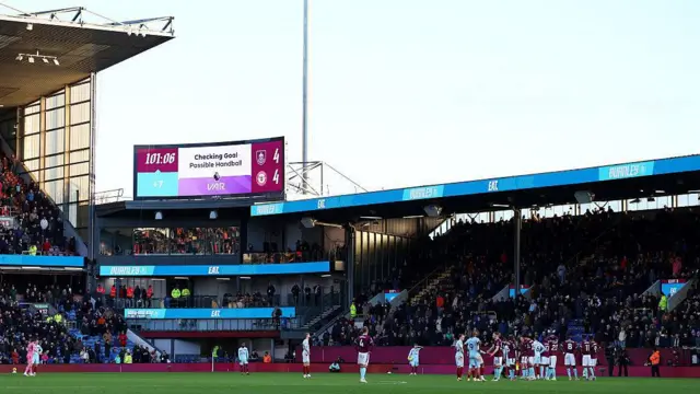 The screen in Turf Moor shows Ashley Barnes' goal under review by VAR