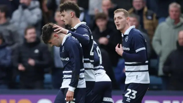 Luke Cundle celebrates with Millwall team-mates