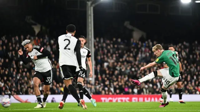 Anthony Gordon of Newcastle United (8) strikes the ball during the Emirates FA Cup Fourth Round match between Fulham and Newcastle United at Craven Cottage