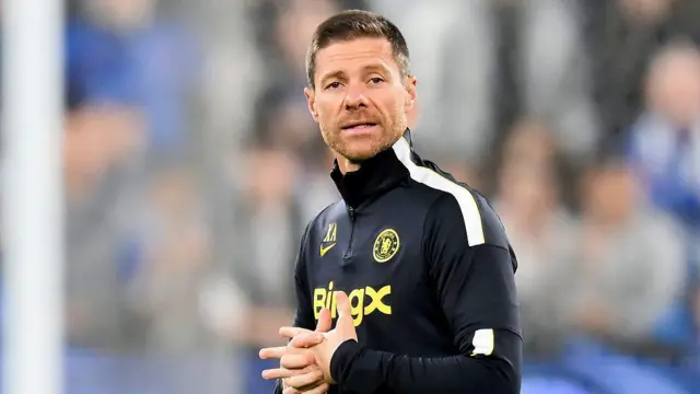 Xabi Alonso clasps his hand together during a Chelsea open training session