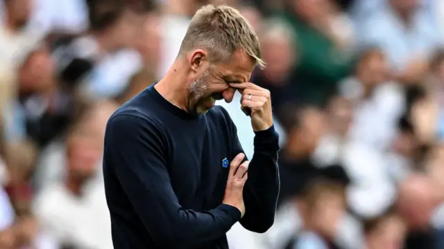 Former West Ham United manager Graham Potter holds his hand to his head