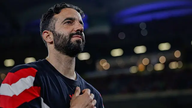 Ruben Amorim looks on under lights in stadium