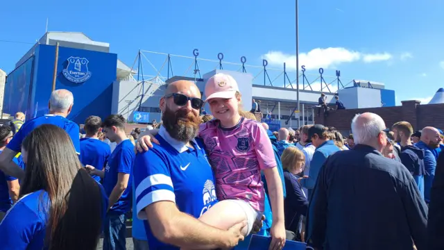 Supporters smiling outside Goodison Park 
