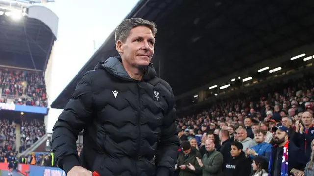 Oliver Glasner walks past fans at Selhurst Park