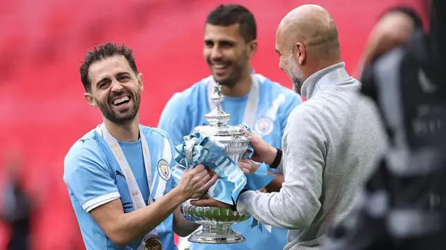 Bernardo Silva of Manchester City and Pep Guardiola with the FA Cup trophy 