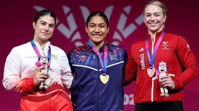 Samoa's gold medal winner Seine Stowers and England's silver medallist Isabella Brown and Wales bronze medal winner Laura Hughes