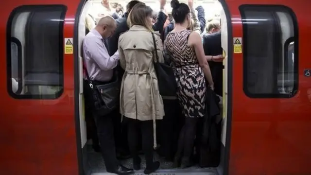 Commuters travel on a crowded Northern Line tube train of the London Underground