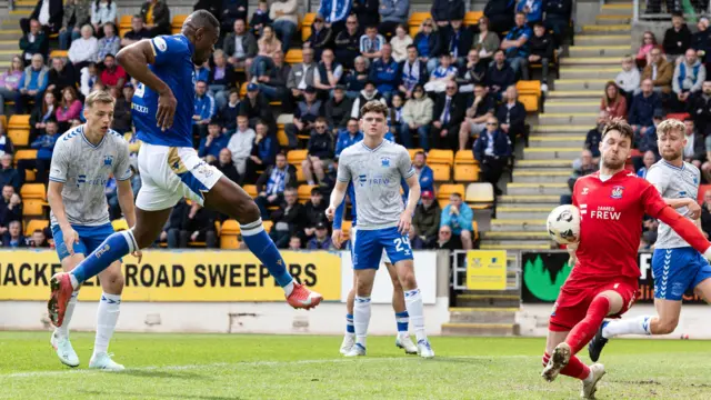 Uche Ikpeazu sees a shot well saved by Kieran O'Hara