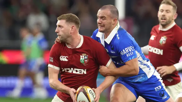 Finn Russell is tackled by a Western Force defender