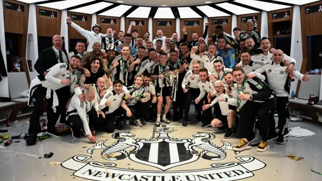 Newcastle players and staff celebrate EFL cup victory in the changing room at Wembley