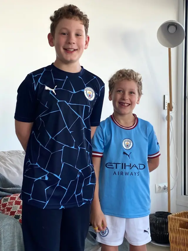 Two grandsons wearing Manchester City kit